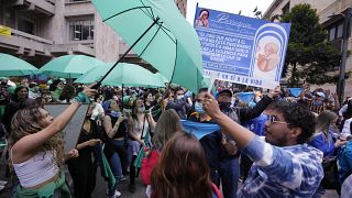Abortion-rights activists (L), and anti-abortion activists protest outside the Constitutional Court as judges review a lawsuit that seeks to decriminalize abortion in Bogota.
