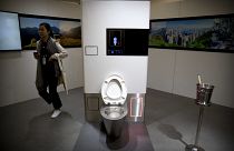 A visitor looks at a display at the Reinvented Toilet Expo in Beijing, Tuesday, Nov. 6, 2018.