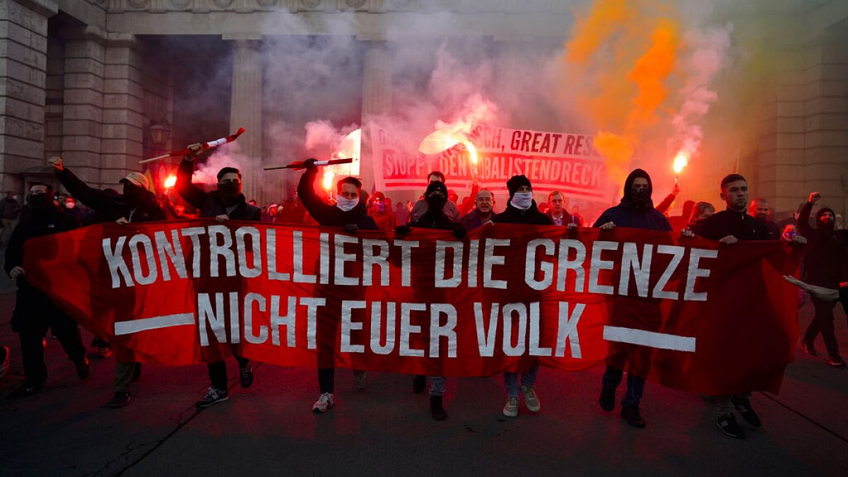 Demonstrators shout slogans and light flares during a demonstration against measures to battle the coronavirus pandemic in Vienna, Austria, Saturday, Nov. 20, 2021.