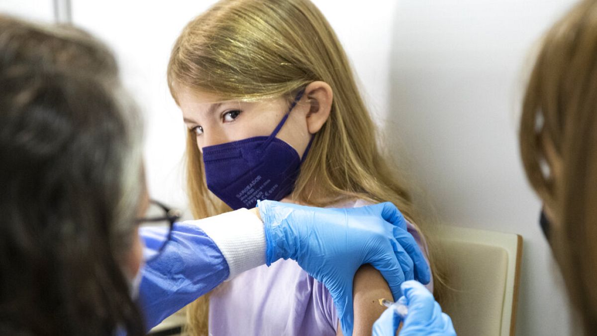 A young patient receives the Pfizer vaccine against COVID-19 in Vienna, Austria, Monday, Nov. 15, 2021. 