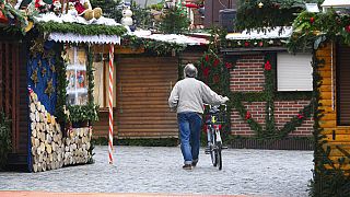 A man walks through a Christmas Market in Berlin
