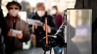 A QR code on a smartphone is scanned during the 2G check at the entrance in front of the Christmas market at the Gendarmenmarkt, Germany.