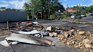 Debris left by demonstrators block a street of Le Gosier, Guadeloupe island, Sunday, Nov.21, 2021.