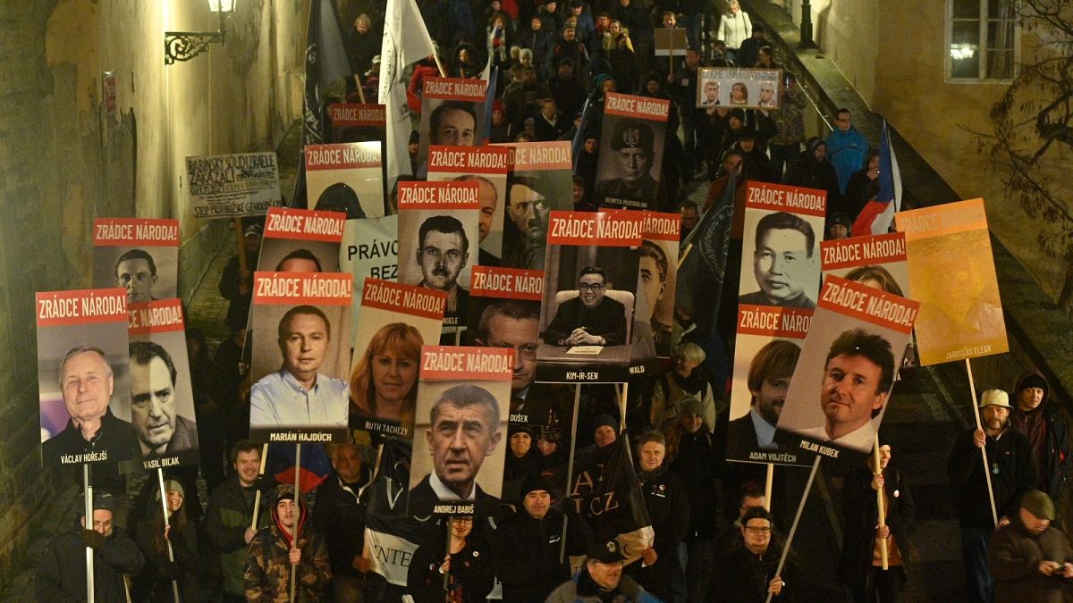 People holding placards protest at a rally in Prague, Czech Republic, Monday, Nov. 22, 2021