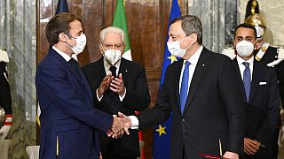 France's President Emmanuel Macron, left, and Italy's Prime Minister Mario Draghi shake hands at the Quirinale presidential palace in Rome, Friday, Nov. 26, 2021.