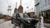 The new electric TX eCity taxi is connected to a sample electric vehicle charger at the Battersea power station in London.