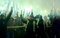 Coal miners hold flares as they gather during protest near government building in Sarajevo, on November 23, 2021.