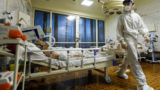 A medic walks between patients with coronavirus at an ICU hospital in Volgograd.