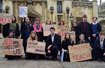 Cambridge University students present King's College with its 'U' grade on climate action.