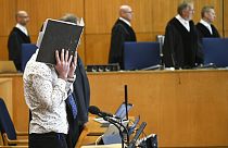 FILE: At the opening of the trial, defendant Taha Al-J. covers his face with a folder in Frankfurt, Germany, Friday, April 24, 2020.