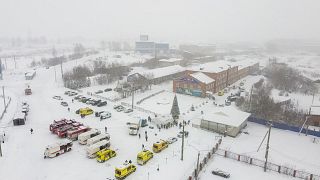 Ambulances and fire engines are parked near the Listvyazhnaya coal mine.