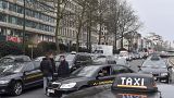 FILE: Taxi drivers use their vehicles to block roads on the inner ring of Brussels during a protest against general taxi regulations and Uber, Tuesday, March 27, 2018.