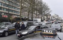 FILE: Taxi drivers use their vehicles to block roads on the inner ring of Brussels during a protest against general taxi regulations and Uber, Tuesday, March 27, 2018.