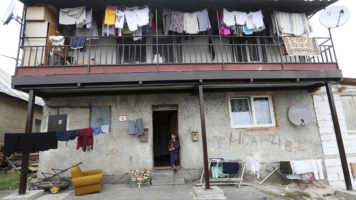 A girl stands outside of a house in a poor Roma settlement near Banska Bystrica, Slovakia.