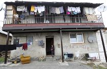 A girl stands outside of a house in a poor Roma settlement near Banska Bystrica, Slovakia.