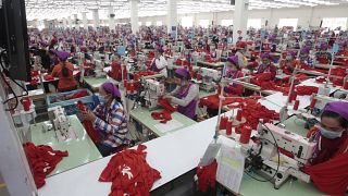 Garment workers sew clothes in a factory in Phnom Penh, Cambodia.