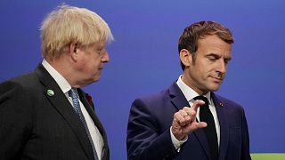 British Prime Minister Boris Johnson, left, greets French President Emmanuel Macron, at the COP26 U.N. Climate Summit in Glasgow