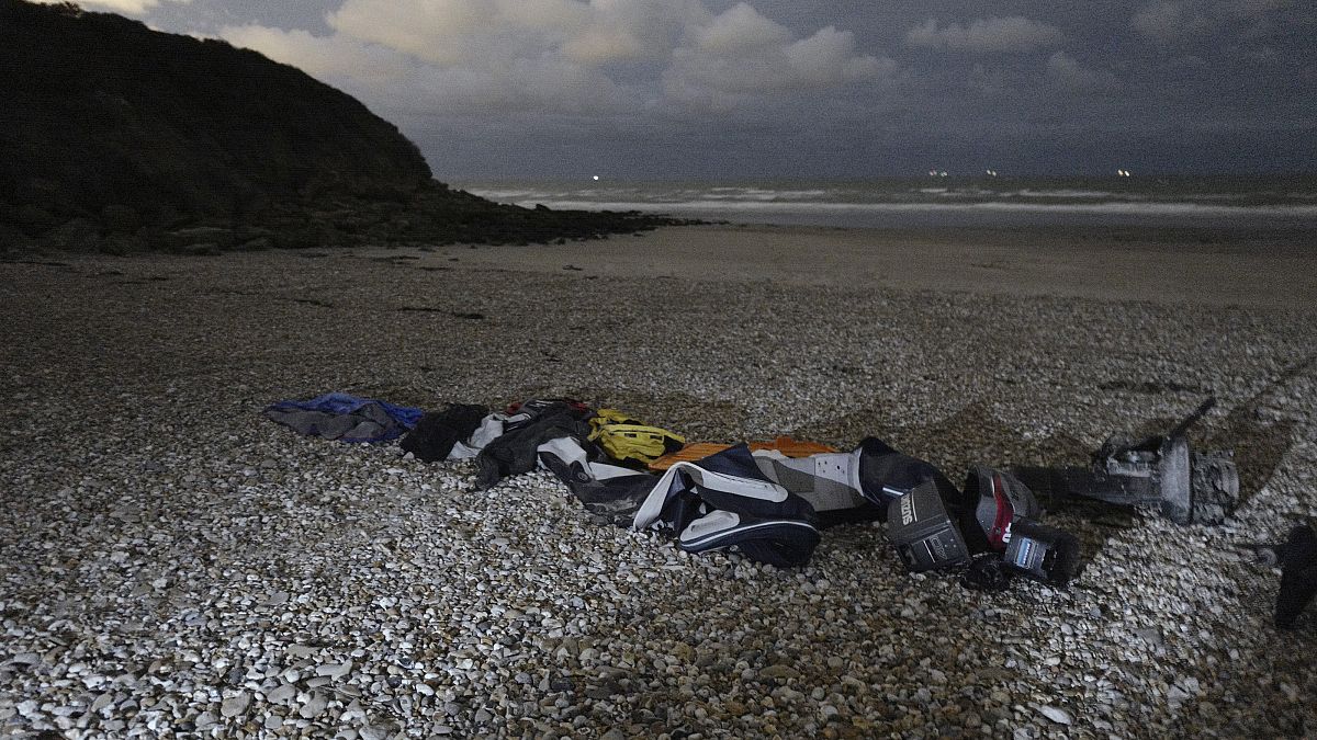 Life jackets, sleeping bags and damaged inflatable small boat are pictured on the shore in Wimereux, northern France, Friday, Nov. 26, 2021 in Calais, northern France.