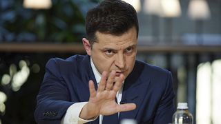 Ukrainian President Volodymyr Zelenskyy gestures while speaking to the media during a news conference in Kyiv.
