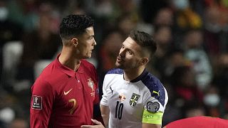 Portugal's Cristiano Ronaldo, left, with Serbia's Dusan Tadic during the World Cup 2022 group A qualifying football match in Lisbon, Nov 14, 2021.