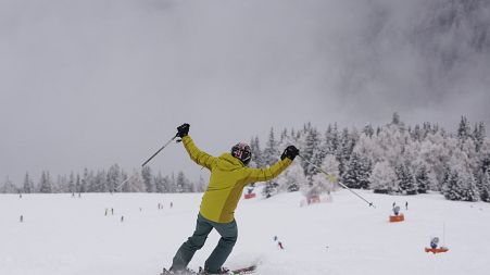 A tourist gestures while skiing, at Plan de Corones ski area, Italy South Tyrol, Nov. 27, 2021.