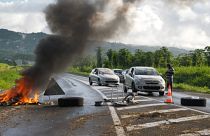 Vehicle passes close to the garbage burning on the ground on the French Caribbean island of Martinique.