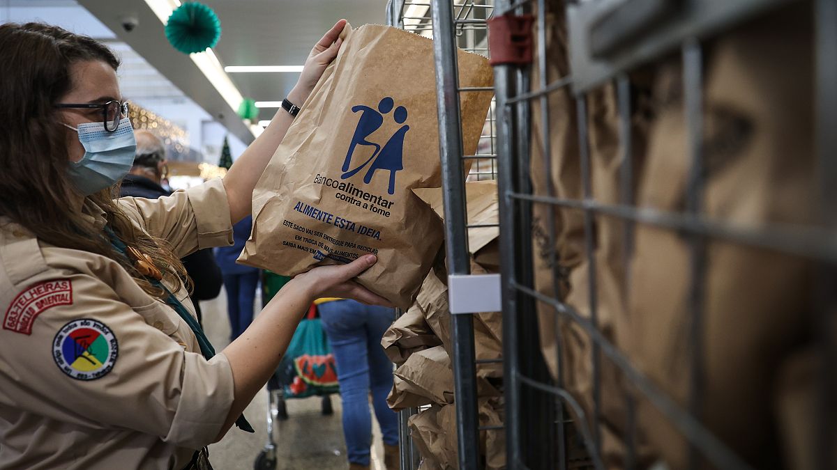 Voluntários trabalham na recolha de alimentos num supermercado, em Lisboa