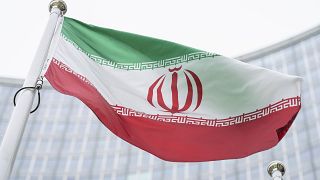 The flag of Iran waves in front of the the International Center building with the headquarters of the International Atomic Energy Agency, IAEA, in Vienna on May 24, 2021.