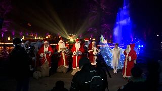 Santa Clauses singing Christmas songs