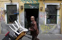 A street vendor pushes a trolley in Athens, Greece