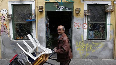 A street vendor pushes a trolley in Athens, Greece