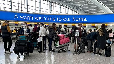 Passengers arriving back at Heathrow Airport today, 29 November.