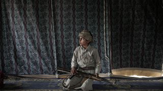 File photo: Kahlan, a 12 year-old former child soldier recruited by Houthi rebels, holds a weapon at a camp for displaced persons where he took shelter with his family