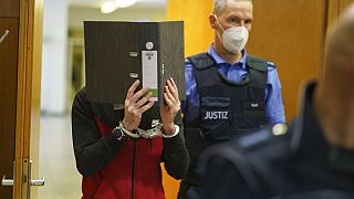 The Iraqi Taha Al-J. is led into the courtroom at Frankfurt's Higher Regional Court before the verdict is pronounced Frankfurt, Germany, Nov. 30, 2021. 