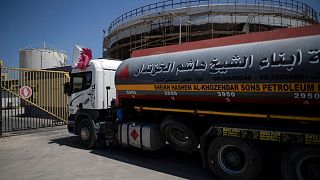 A fuel truck with a Qatari flag enters the Nusseirat power plant, in the central Gaza Strip