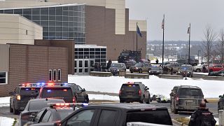 Dozens of police, fire, and EMS personnel work on the scene of a shooting at Oxford High School, Tuesday, Nov. 30, 2021, In Oxford Township, Mich.