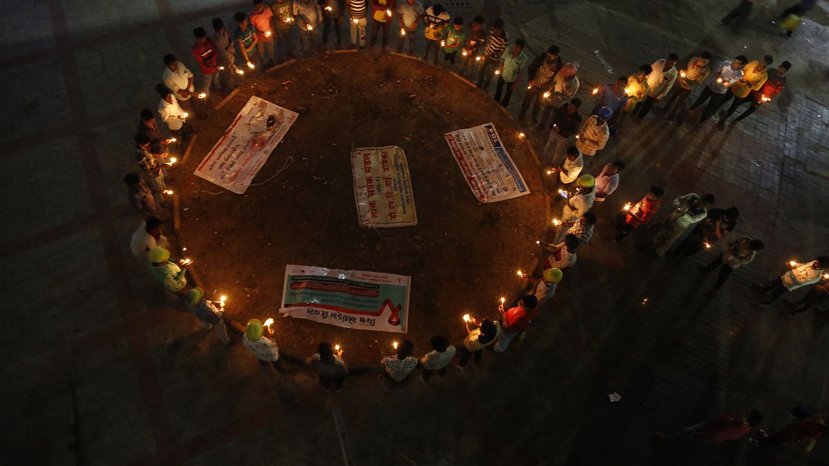 Miembros de una organización no gubernamental forman un lazo, símbolo universal de concienciación y apoyo a las personas que viven con el VIH, 30/11/2021, 	Ahmedabad, India