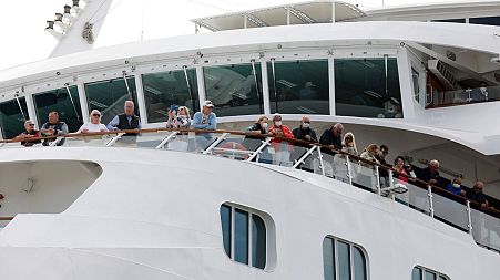 A luxury liner docked in Cape Town yesterday, as the WHO updated its travel advice.