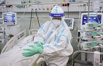An ICU staff member puts on an extra pair of gloves in the COVID-19 ICU unit of Marius Nasta National Pneumology Institute in Bucharest, Romania, September 2021