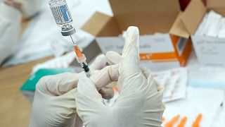 A registered nurse fills a syringe with the Johnson & Johnson COVID-19 vaccine.