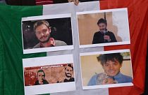 People hold an Italian flag with photos of Giulio Regeni during a 2016 demonstration in front of Egypt's embassy in Rome.