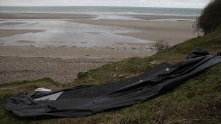 A damaged inflatable small boat is pictured on the shore in Wimereux, northern France, Thursday, 25 November 2021.
