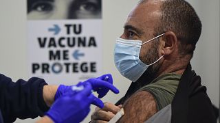 A man receives a shot of the Moderna vaccine, part of a COVID-19 vaccination campaign, in San Sebastian, northern Spain, Thursday, Dec. 2, 2021