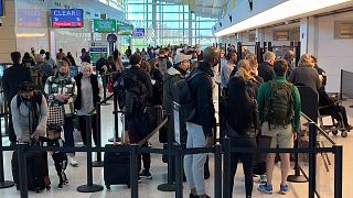 People queue at a US airport