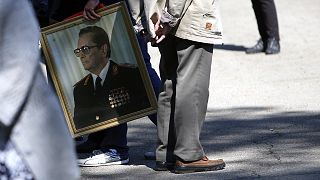 Supporters of the late Yugoslav communist president Josip Broz Tito with his picture wait in front of his memorial complex prior a wreath laying ceremony in Belgrade, Serbia, 