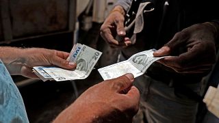 A Syrian man pays with Turkish lira at a gas station in the town of Sarmada in Syria's northwestern Idlib province, on June 15, 2020. 