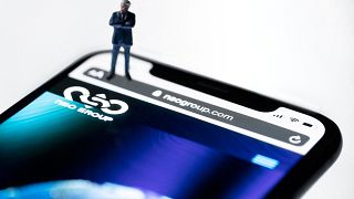 This studio photographic illustration shows a smartphone with the website of Israel's NSO Group which features 'Pegasus' spyware, on display in Paris on July 21, 2021. 
