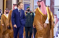 Saudi Crown Prince Mohammed bin Salman greets French President Emmanuel Macron upon his arrival in Jiddah, Saudi Arabia,  Saturday, Dec. 4, 2021.