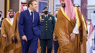 Saudi Crown Prince Mohammed bin Salman greets French President Emmanuel Macron upon his arrival in Jiddah, Saudi Arabia,  Saturday, Dec. 4, 2021.