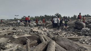 Rescuers and villagers in Candi Puro village on the island of East Java